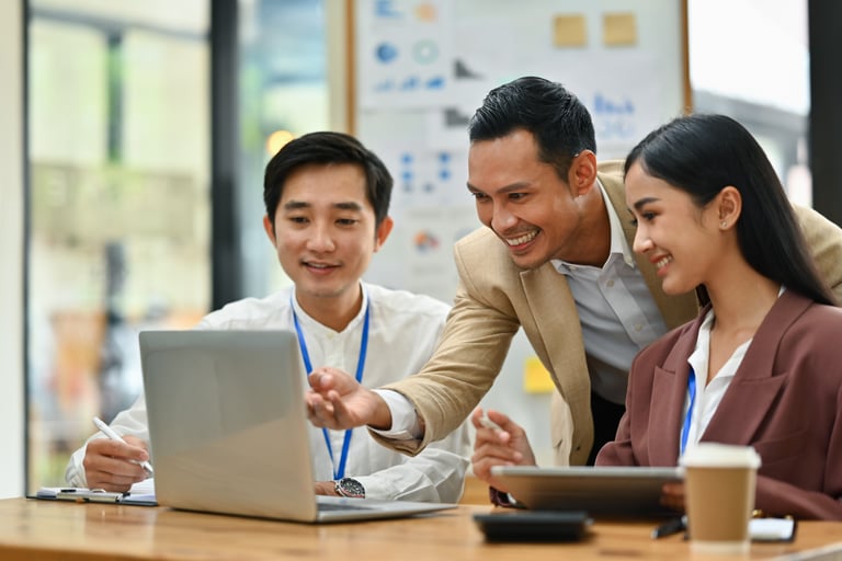 businesspeople-analyzing-financial-data-on-laptop-2024-11-25-13-44-02-utc